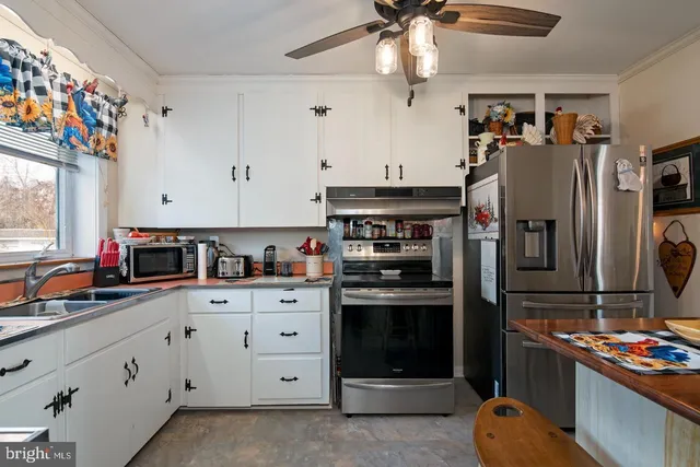 a kitchen with stainless steel appliances granite countertop a refrigerator and a stove