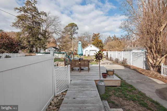 a view of a house with a big yard and large tree