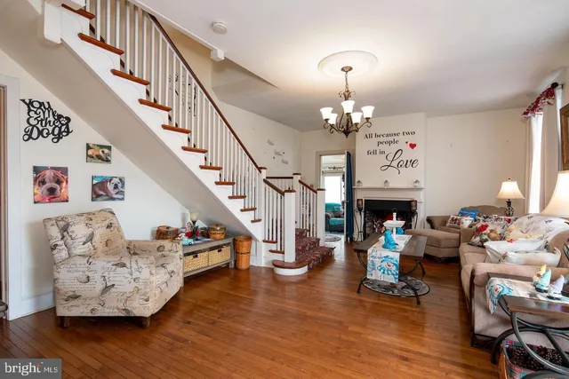 a living room with fireplace furniture and a wooden floor