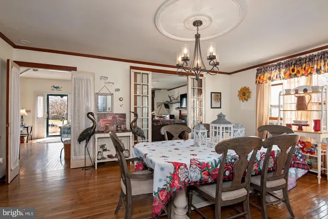 a very nice looking dining room with furniture window and wooden floor
