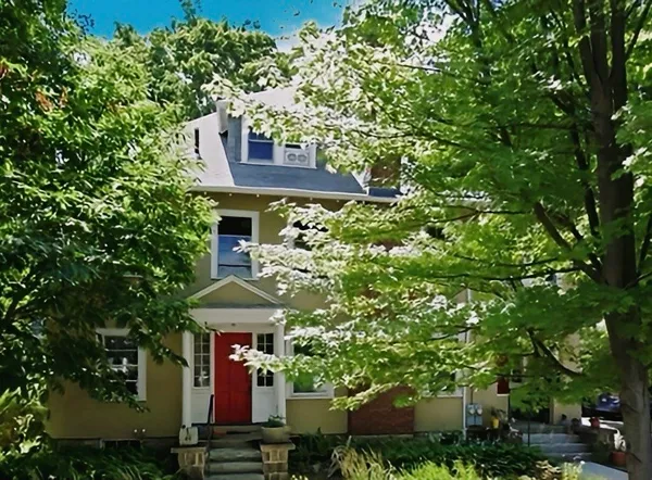 front view of a house with a tree