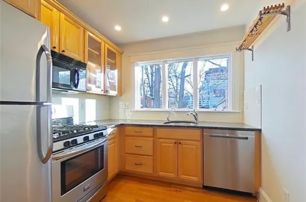a kitchen with stainless steel appliances granite countertop a stove and a microwave