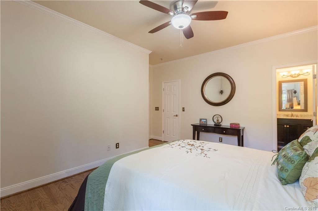 5730 Closeburn Road, Unit M Charlotte, NC 28210 - Photo 12 of 21 a bedroom with a bed and a chandelier