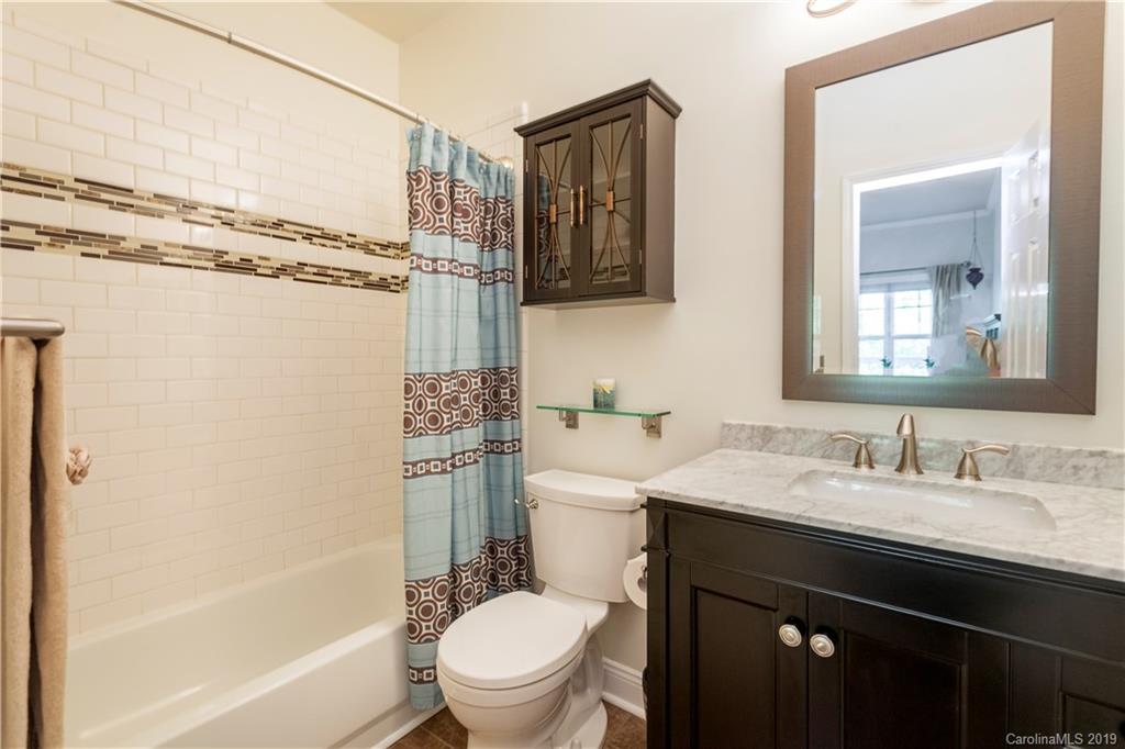 5730 Closeburn Road, Unit M Charlotte, NC 28210 - Photo 13 of 21 a bathroom with a sink a toilet a mirror and shower
