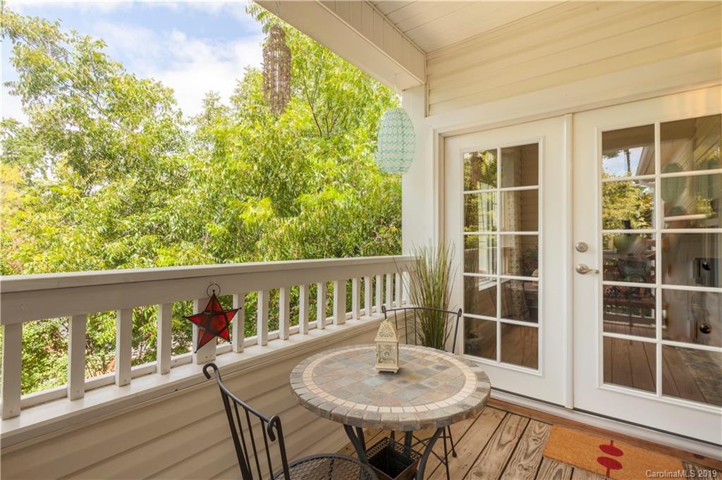 5730 Closeburn Road, Unit M Charlotte, NC 28210 - Photo 18 of 21 a view of a balcony with a table and chairs