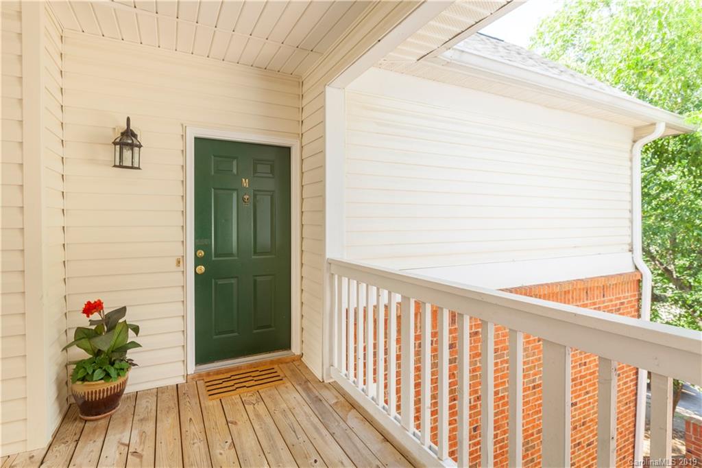 5730 Closeburn Road, Unit M Charlotte, NC 28210 - Photo 19 of 21 a view of a balcony with wooden floor and a potted plant