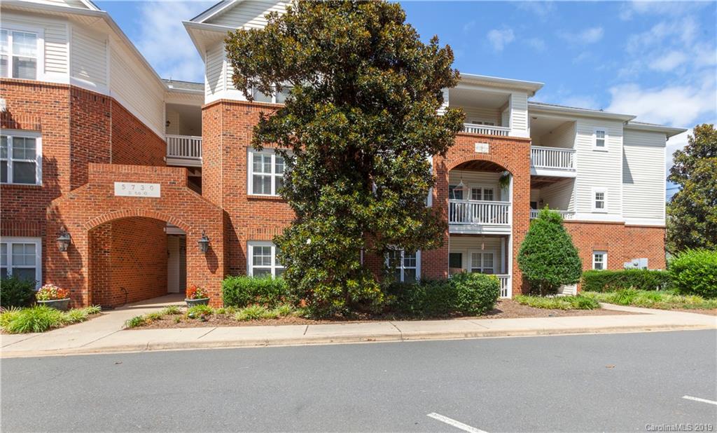 5730 Closeburn Road, Unit M Charlotte, NC 28210 - Photo 21 of 21 front view of a brick house with a small yard