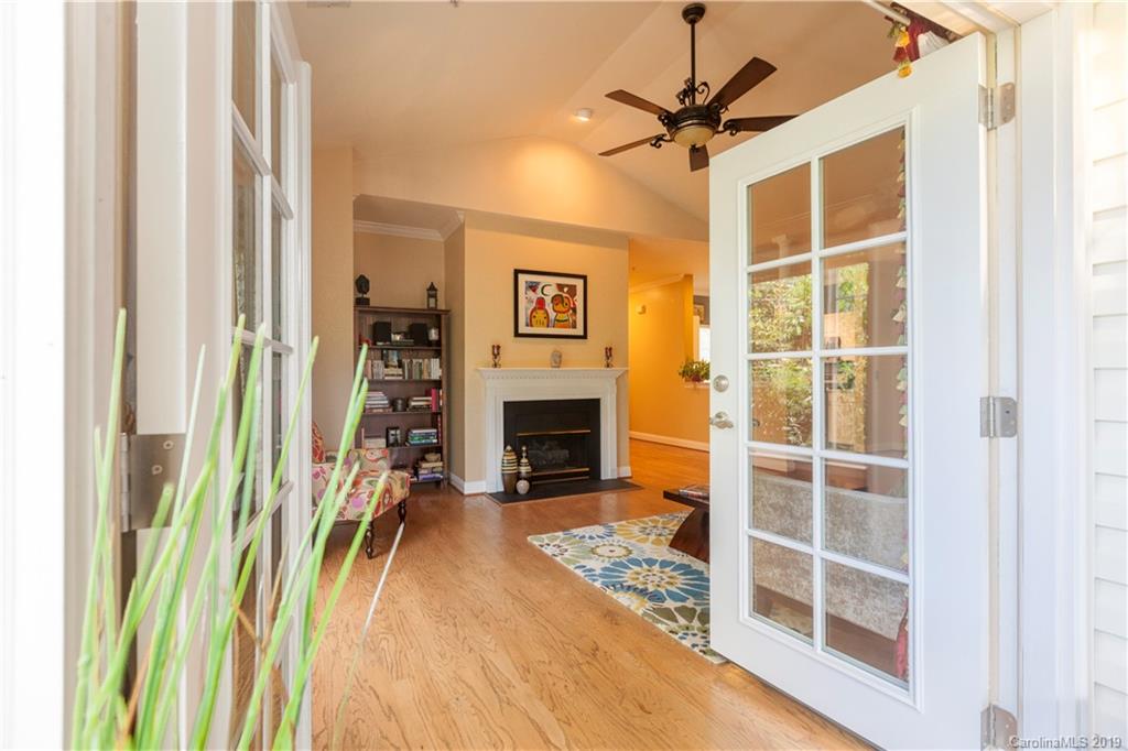 5730 Closeburn Road, Unit M Charlotte, NC 28210 - Photo 4 of 21 a view of a livingroom with a fireplace and a chandelier fan