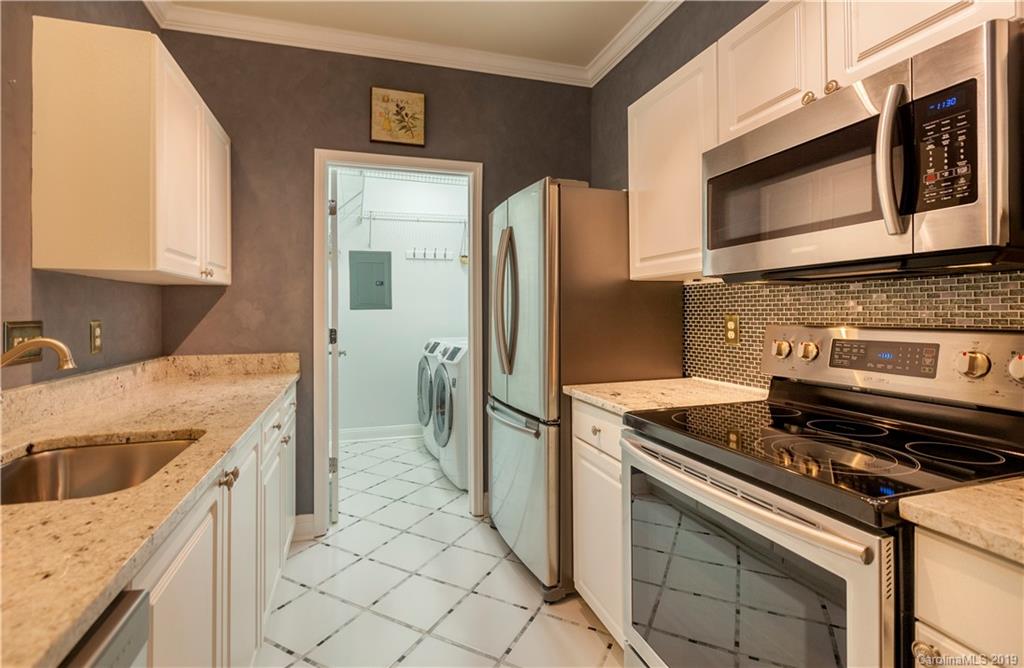 5730 Closeburn Road, Unit M Charlotte, NC 28210 - Photo 6 of 21 a kitchen with stainless steel appliances granite countertop a sink stove and refrigerator