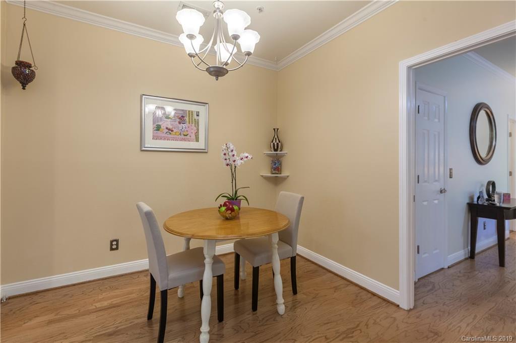 5730 Closeburn Road, Unit M Charlotte, NC 28210 - Photo 9 of 21 a view of a dining room with furniture and wooden floor