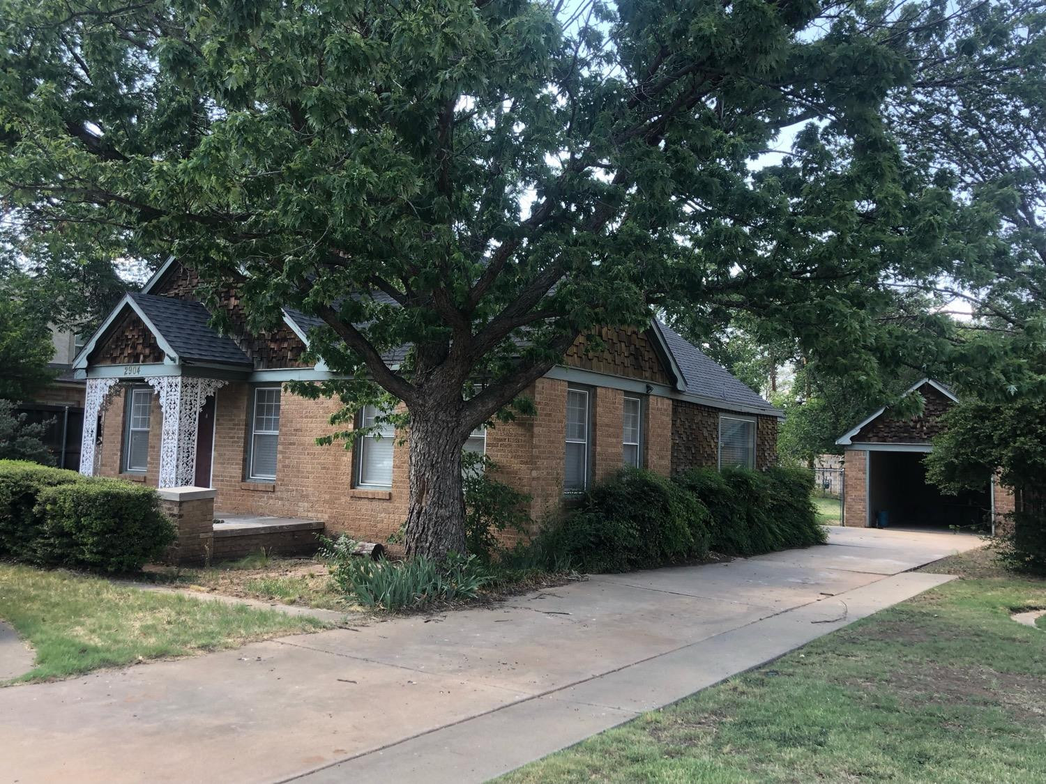 2904 20th Street Lubbock, TX 79410 - Photo 1 of 35 a front view of a house with garden