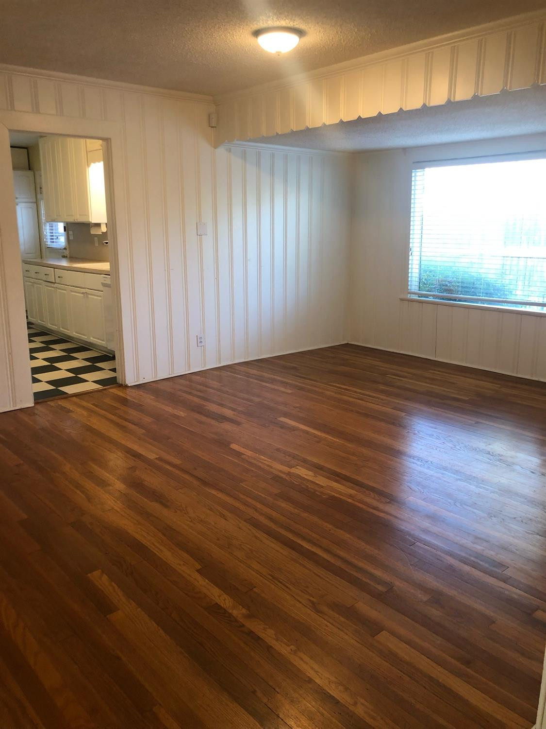 2904 20th Street Lubbock, TX 79410 - Photo 11 of 35 an empty room with wooden floor and windows