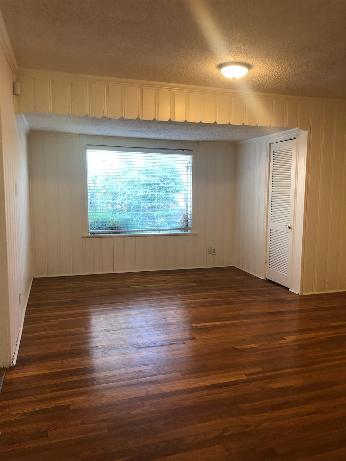 2904 20th Street Lubbock, TX 79410 - Photo 12 of 35 an empty room with wooden floor and windows