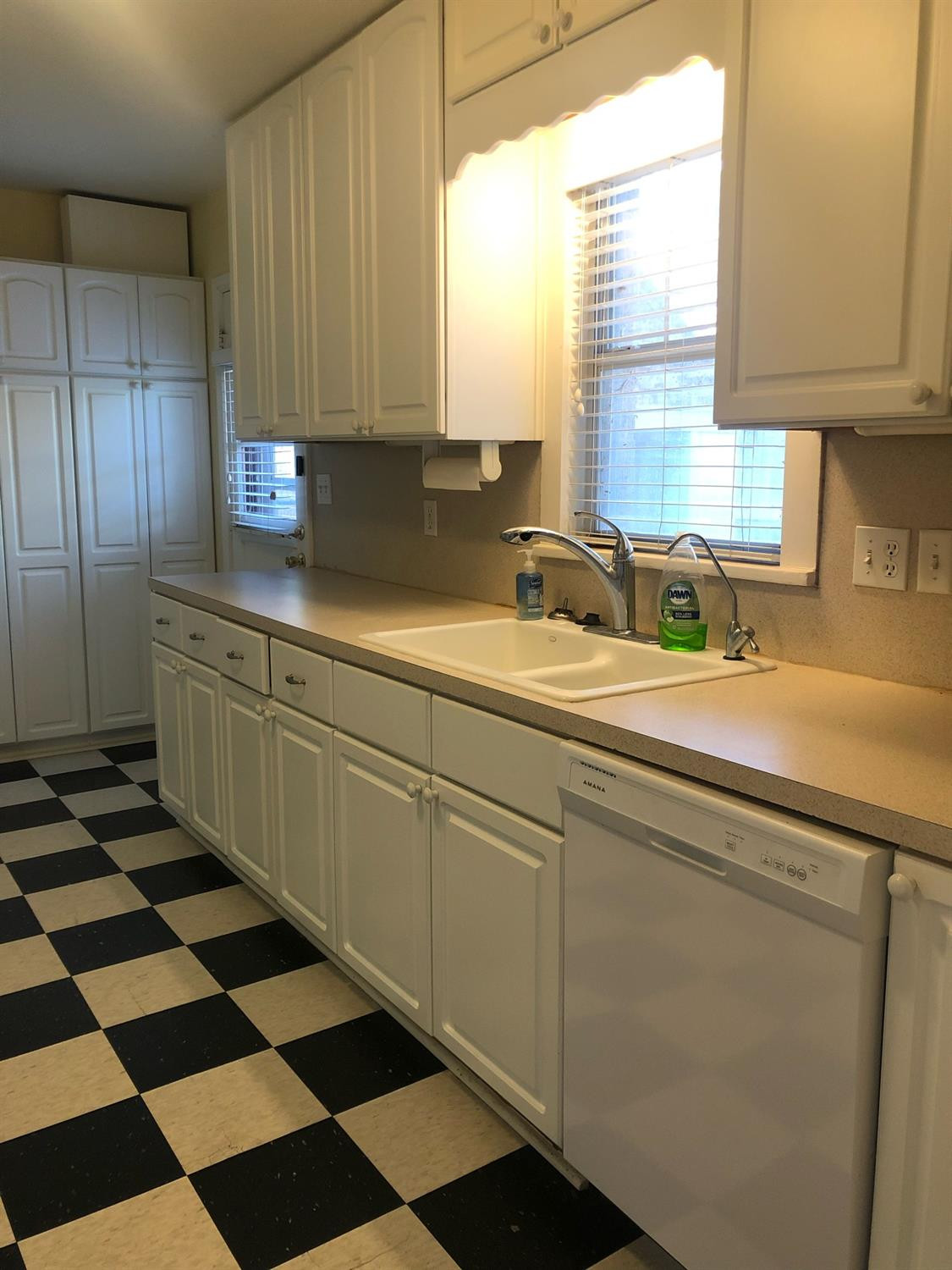2904 20th Street Lubbock, TX 79410 - Photo 17 of 35 a kitchen with a sink a refrigerator and cabinets