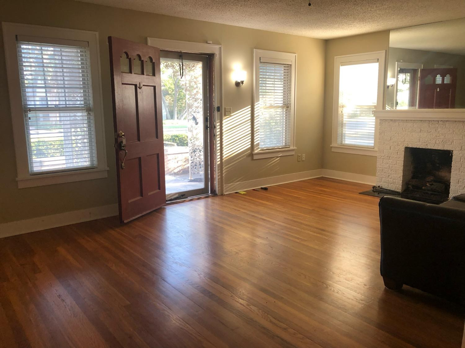 2904 20th Street Lubbock, TX 79410 - Photo 3 of 35 a view of an empty room with wooden floor and a window