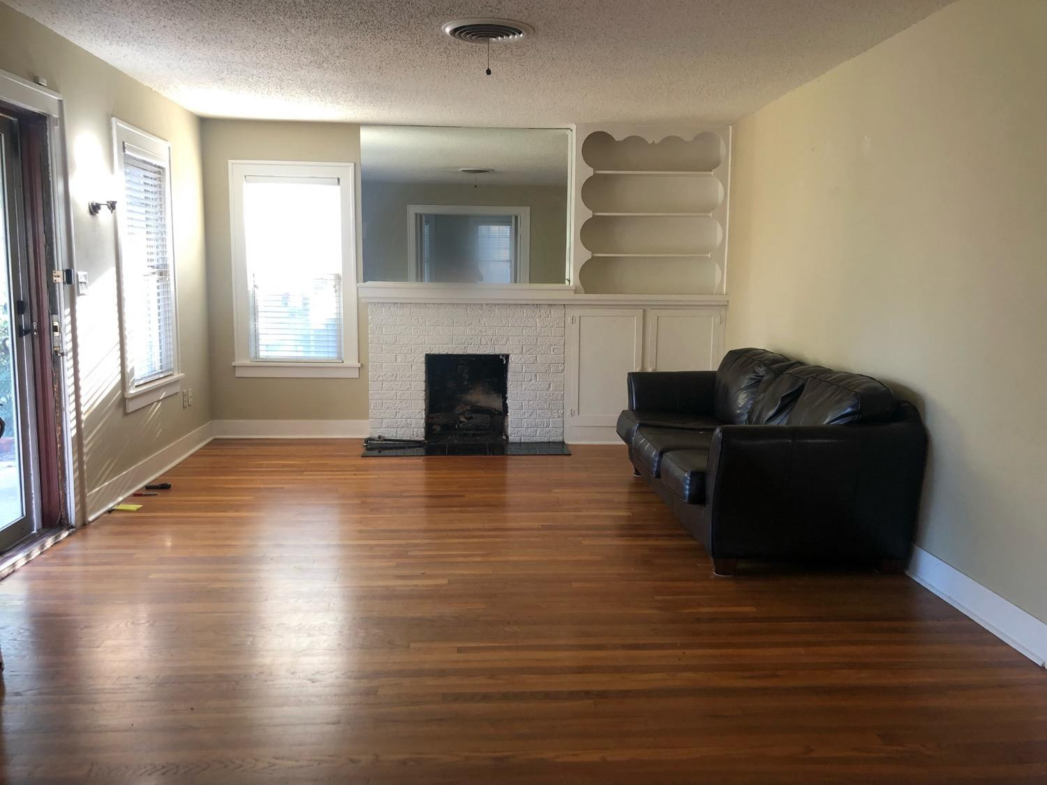 2904 20th Street Lubbock, TX 79410 - Photo 4 of 35 a living room with furniture wooden floor and a fireplace