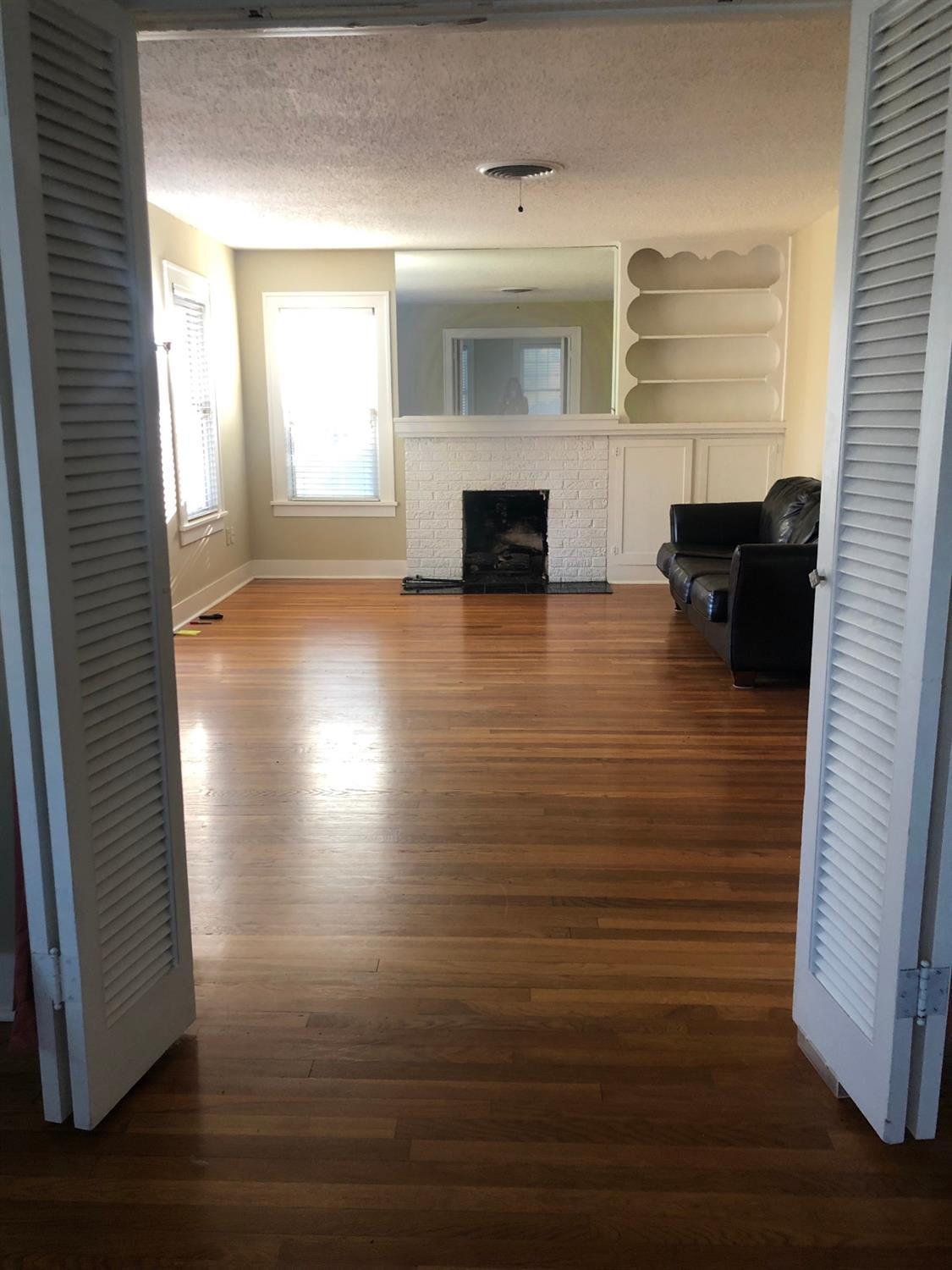 2904 20th Street Lubbock, TX 79410 - Photo 5 of 35 an empty room with wooden floor and fireplace