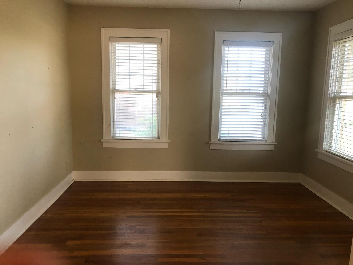 2904 20th Street Lubbock, TX 79410 - Photo 9 of 35 a view of an empty room with wooden floor and a window