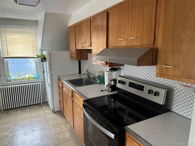 a kitchen with a stove and a sink