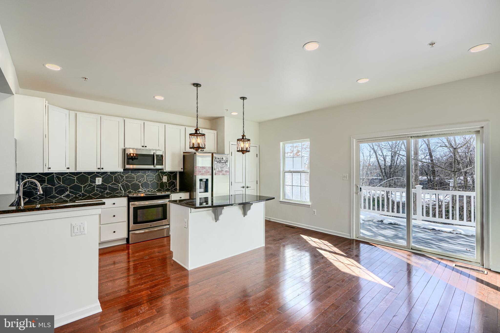 7366 Matchbox Alley Elkridge, MD 21075 - Photo 11 of 32 a kitchen with stainless steel appliances a stove a sink and a refrigerator