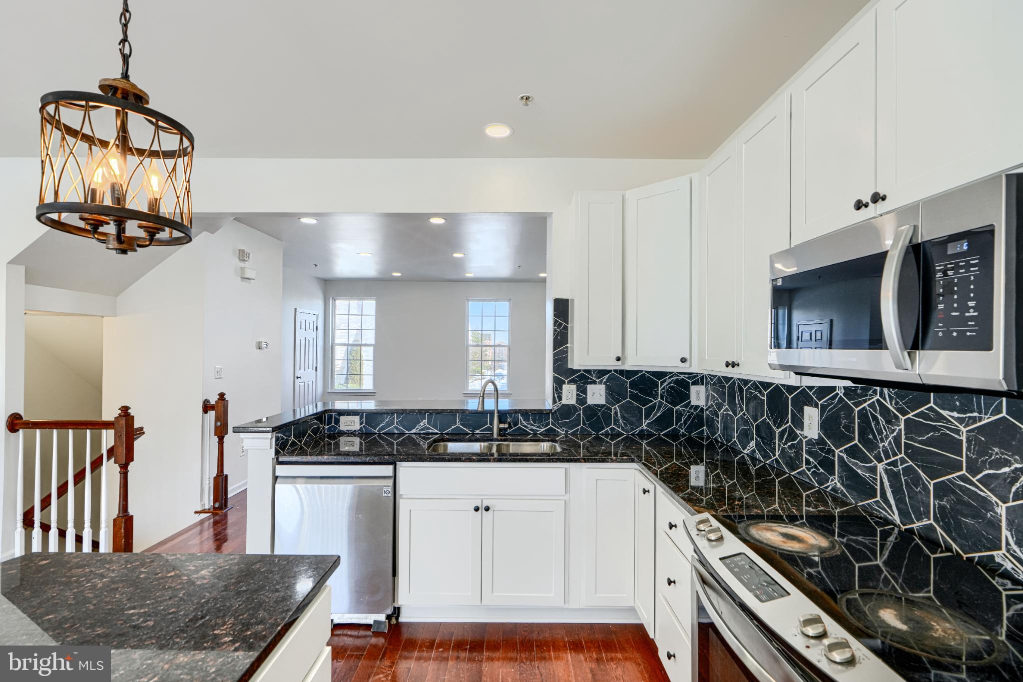 7366 Matchbox Alley Elkridge, MD 21075 - Photo 14 of 32 a kitchen with stainless steel appliances granite countertop a stove a sink and a microwave