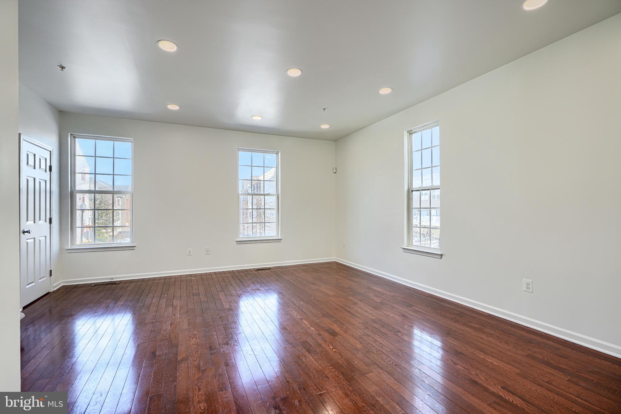 7366 Matchbox Alley Elkridge, MD 21075 - Photo 16 of 32 an empty room with wooden floor and windows