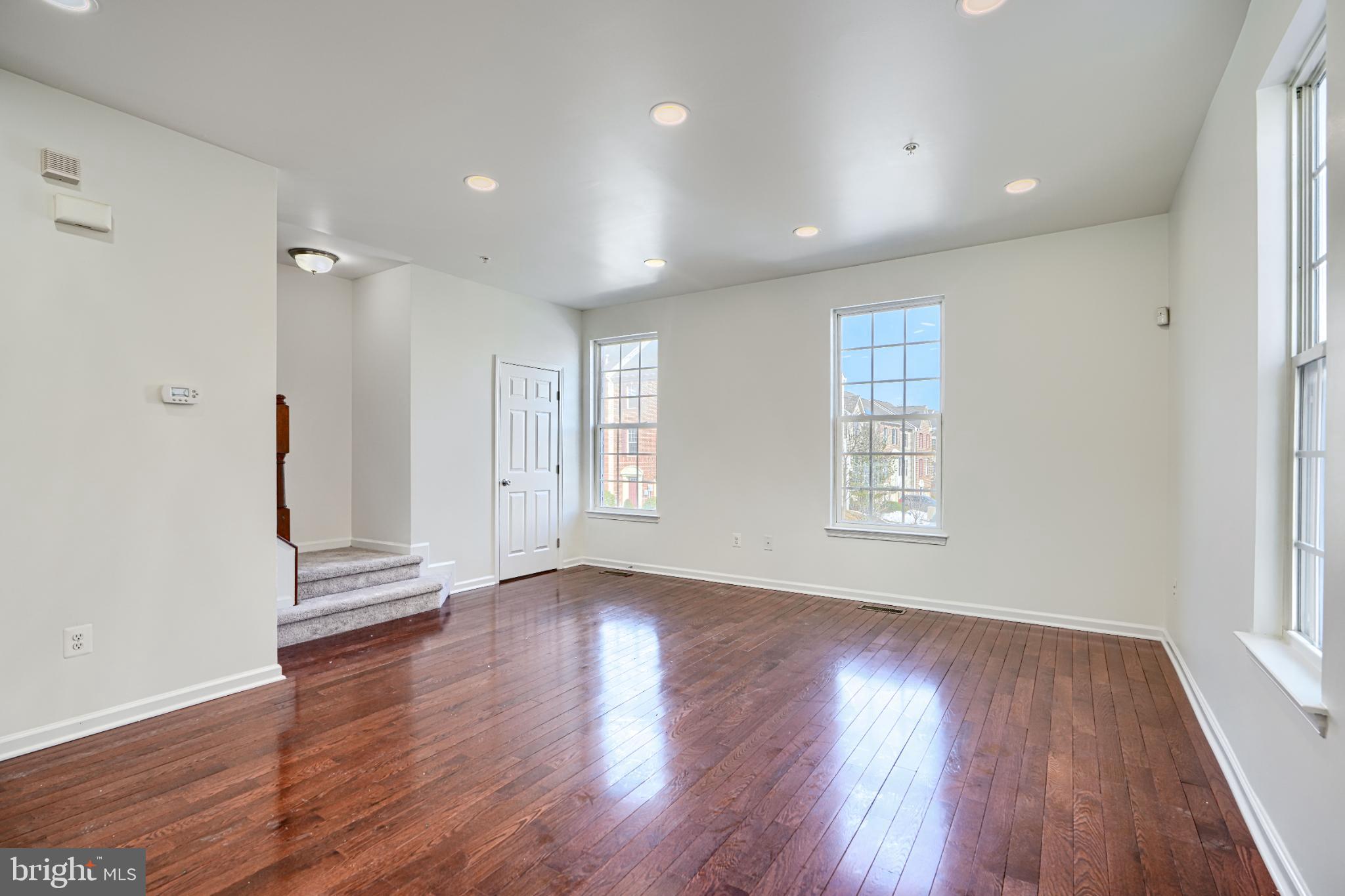 7366 Matchbox Alley Elkridge, MD 21075 - Photo 17 of 32 an empty room with wooden floor and windows