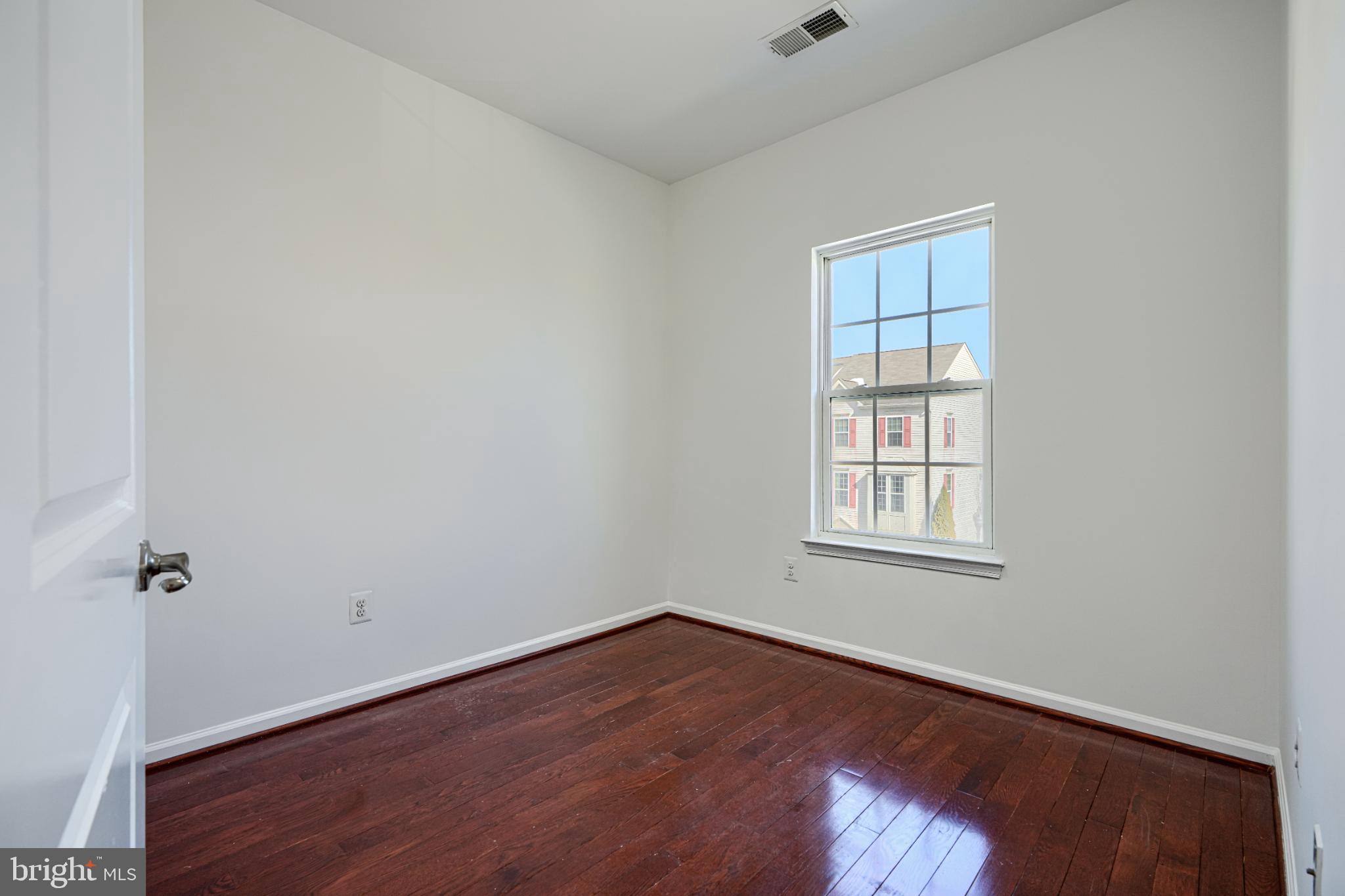 7366 Matchbox Alley Elkridge, MD 21075 - Photo 25 of 32 an empty room with wooden floor and windows