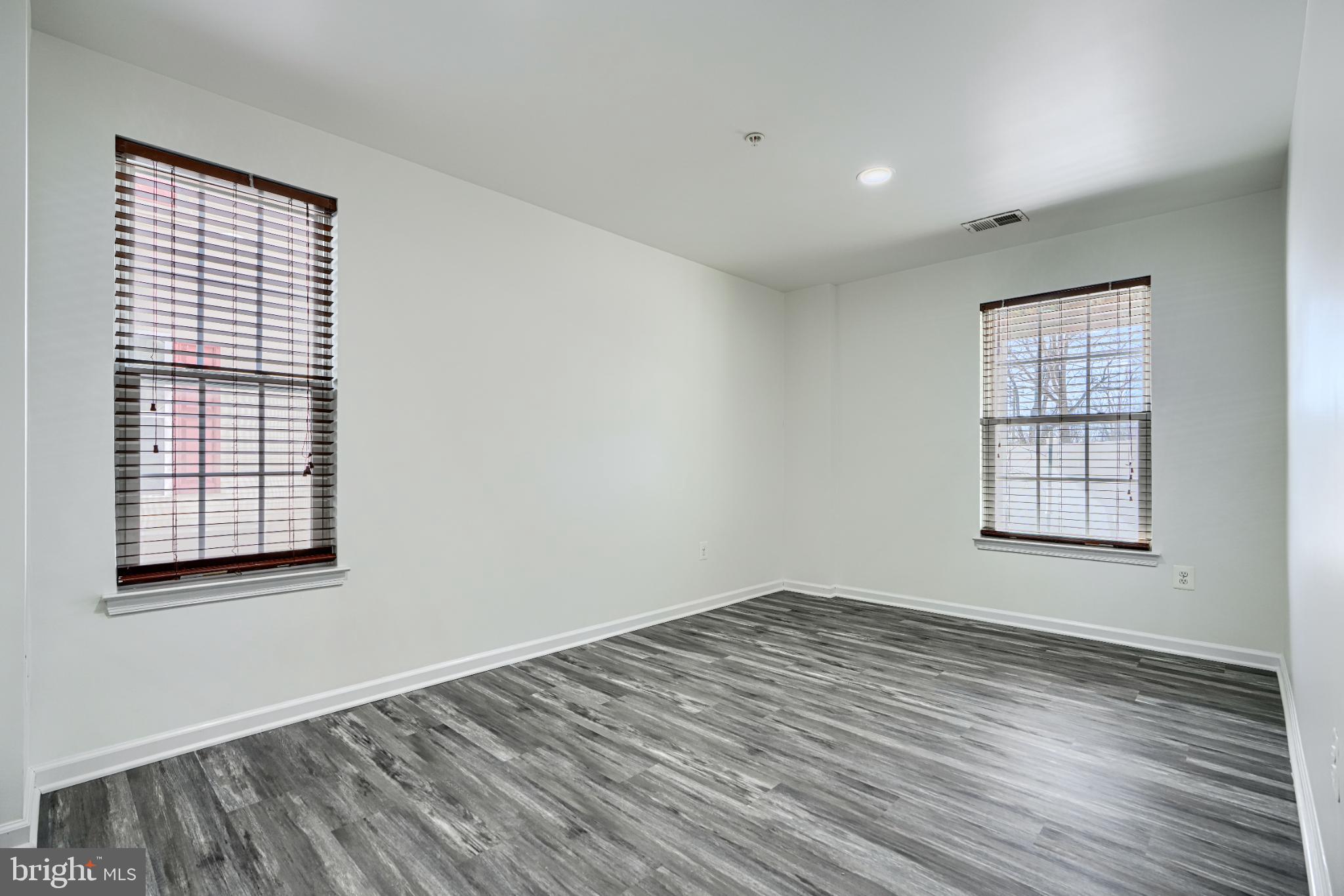 7366 Matchbox Alley Elkridge, MD 21075 - Photo 6 of 32 an empty room with wooden floor and windows