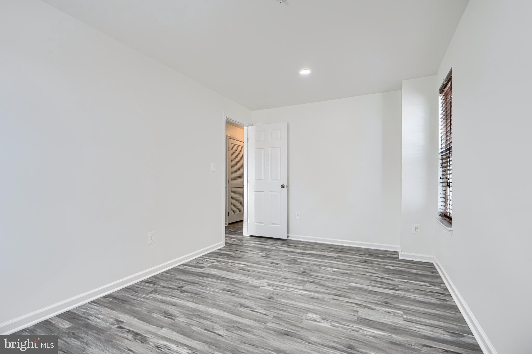 7366 Matchbox Alley Elkridge, MD 21075 - Photo 7 of 32 a view of an empty room with wooden floor