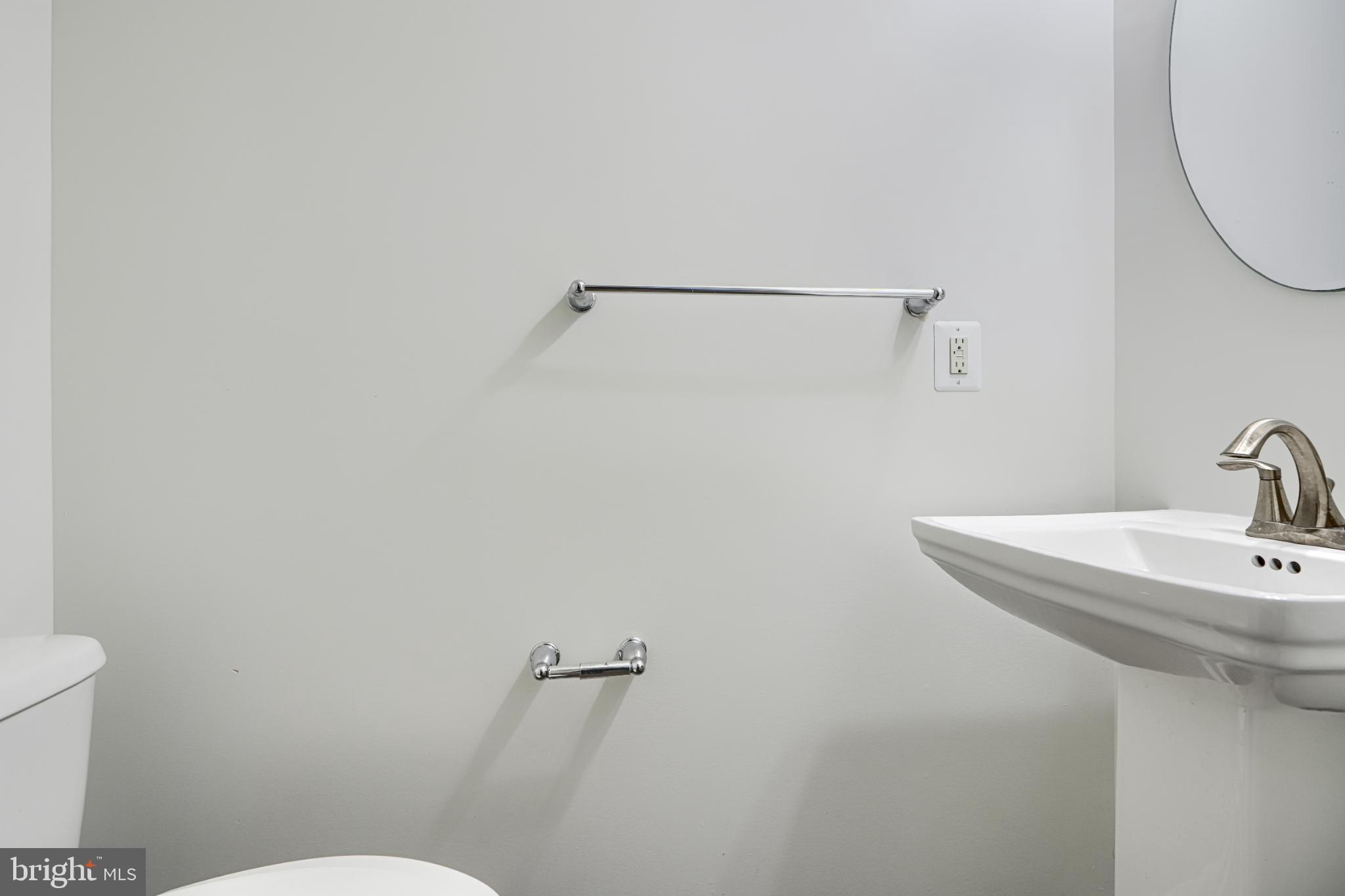 7366 Matchbox Alley Elkridge, MD 21075 - Photo 8 of 32 a bathroom with a sink a toilet and a mirror