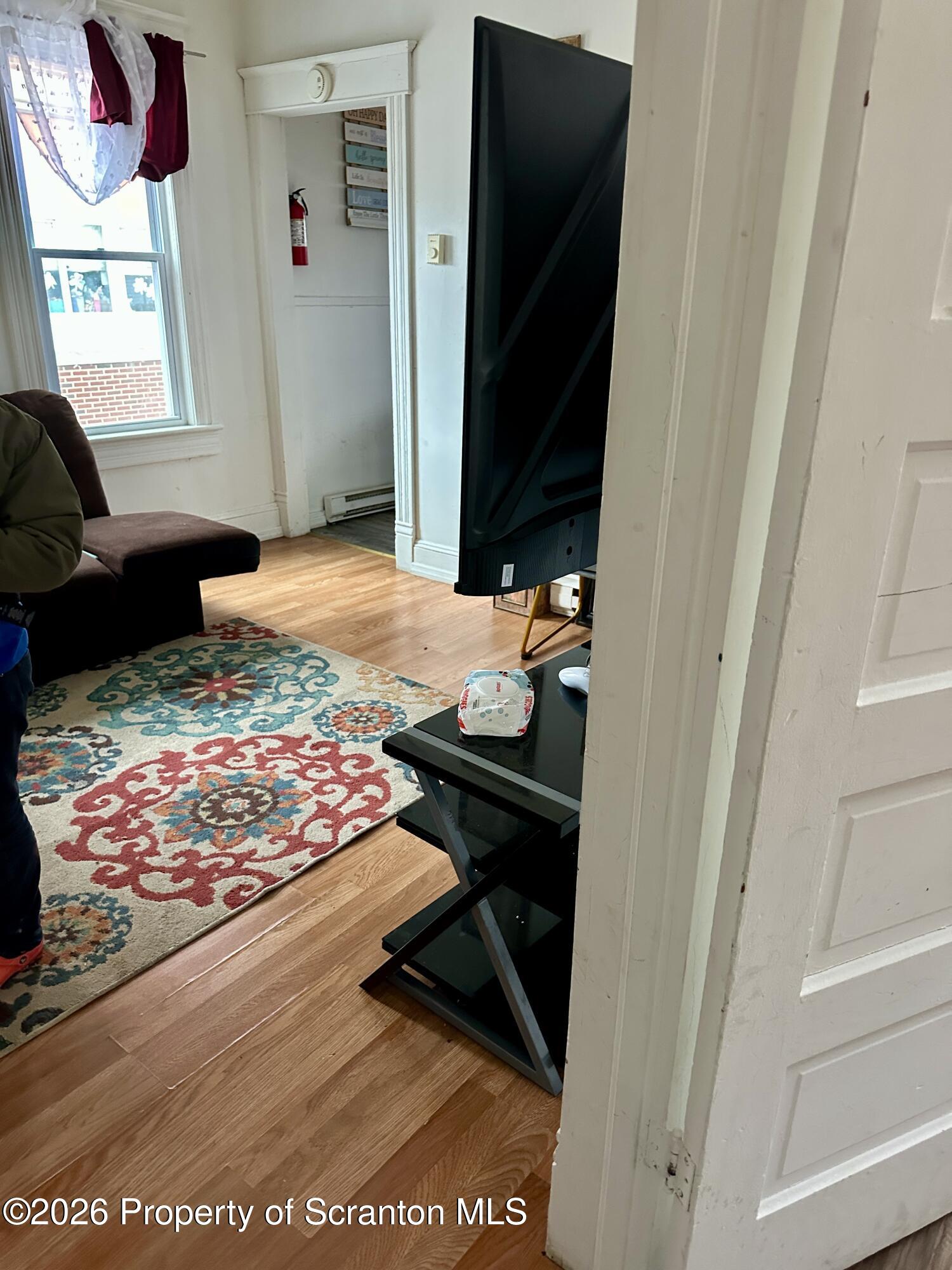 1129-1131 Hampton Street Scranton, PA 18504 - Photo 15 of 45 a bedroom with a bed and a window