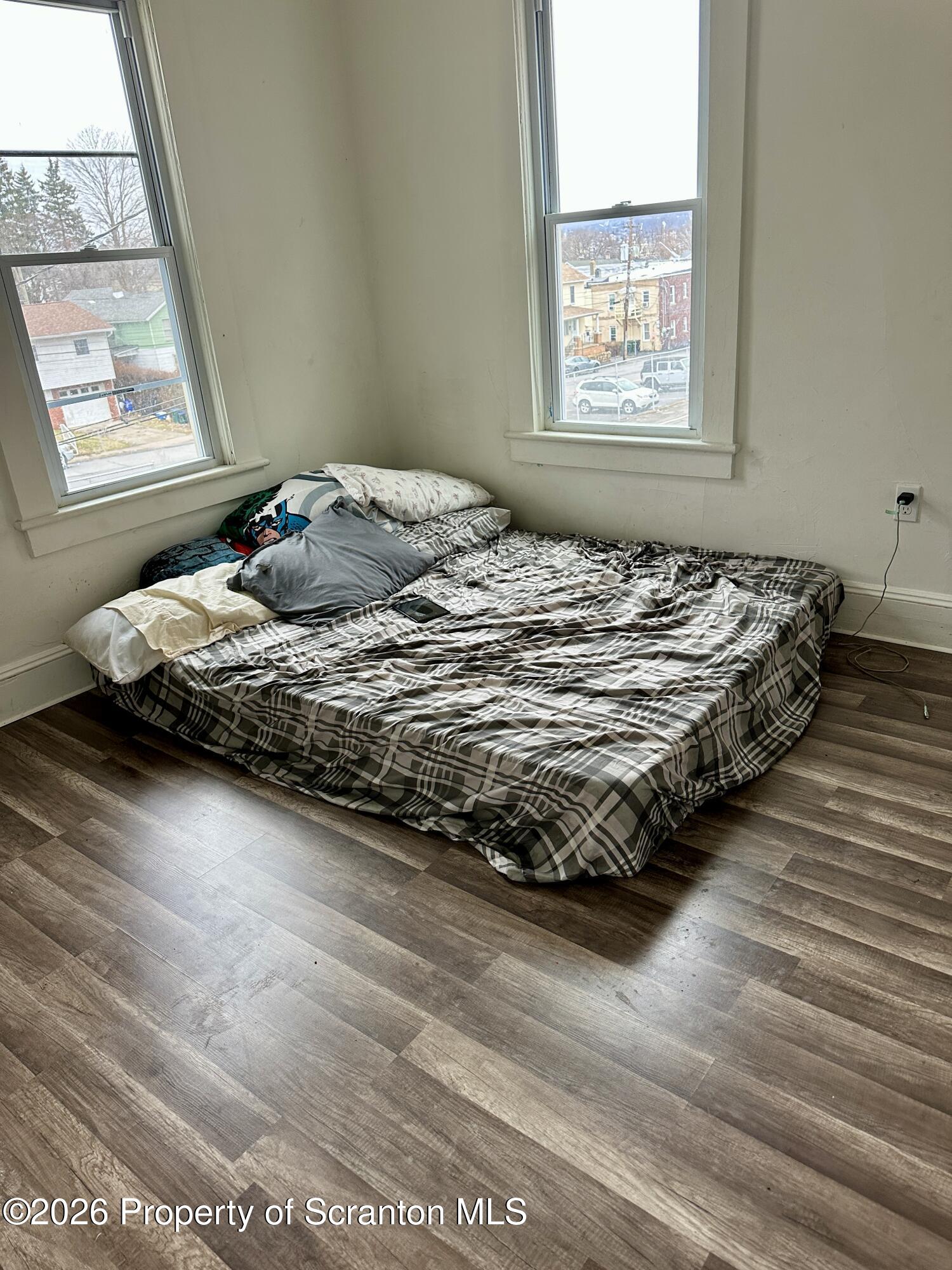 1129-1131 Hampton Street Scranton, PA 18504 - Photo 17 of 45 a bed sitting in a bedroom next to a window