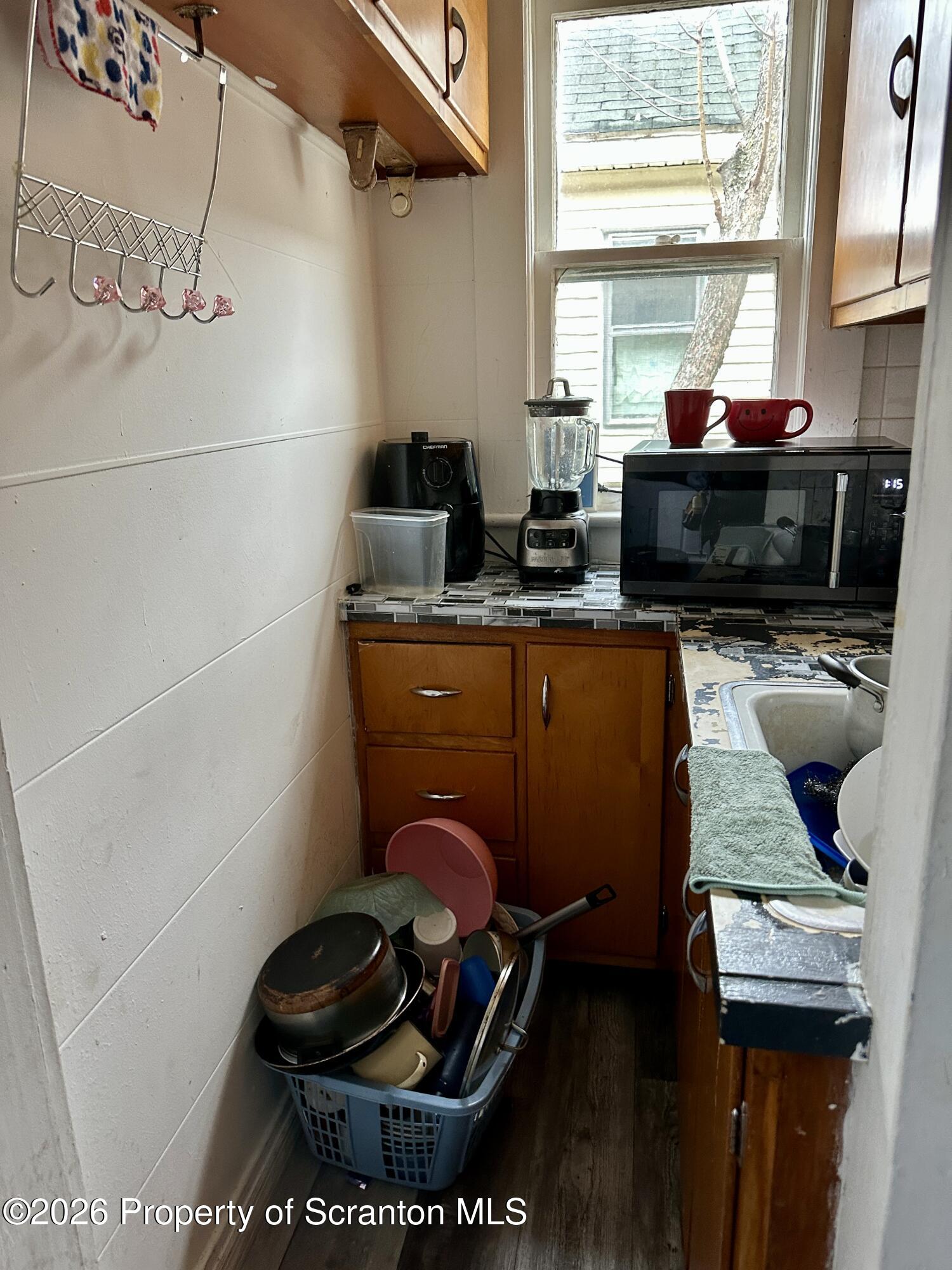 1129-1131 Hampton Street Scranton, PA 18504 - Photo 18 of 45 a kitchen with a sink a stove and a microwave