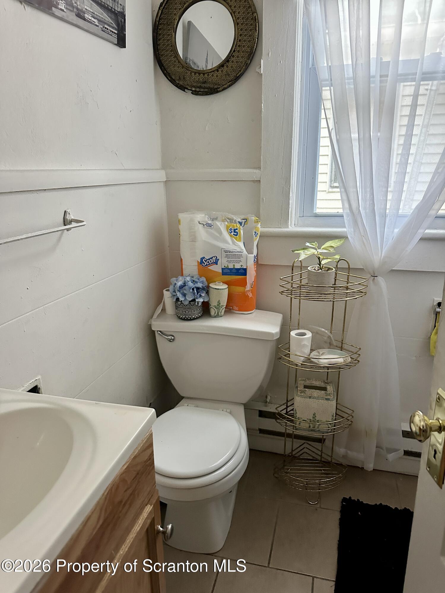 1129-1131 Hampton Street Scranton, PA 18504 - Photo 20 of 45 a bathroom with a toilet a sink and bathtub
