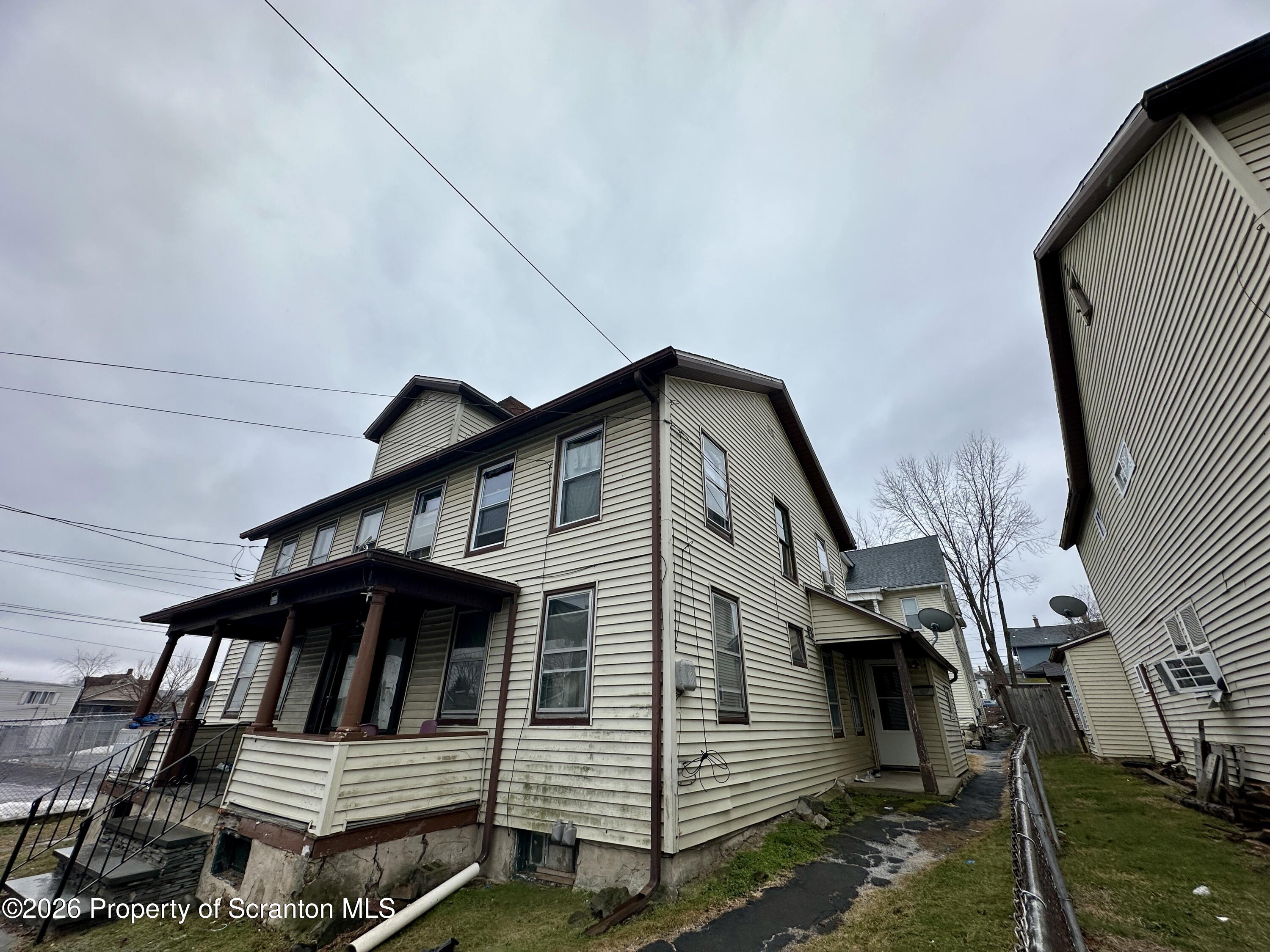 1129-1131 Hampton Street Scranton, PA 18504 - Photo 2 of 45 a view of a house with a wooden deck