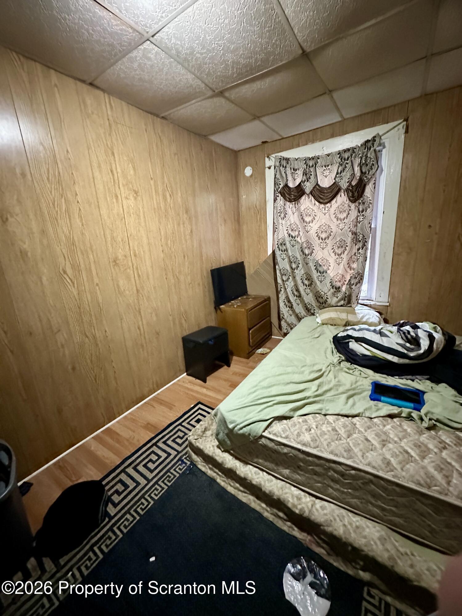 1129-1131 Hampton Street Scranton, PA 18504 - Photo 29 of 45 a bedroom with a bed and a window