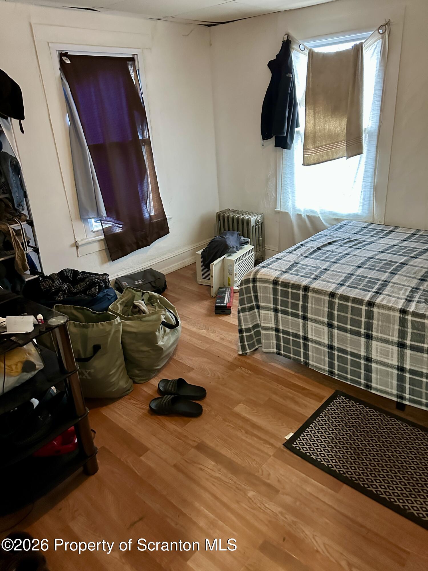 1129-1131 Hampton Street Scranton, PA 18504 - Photo 33 of 45 a bedroom with a bed and cabinets