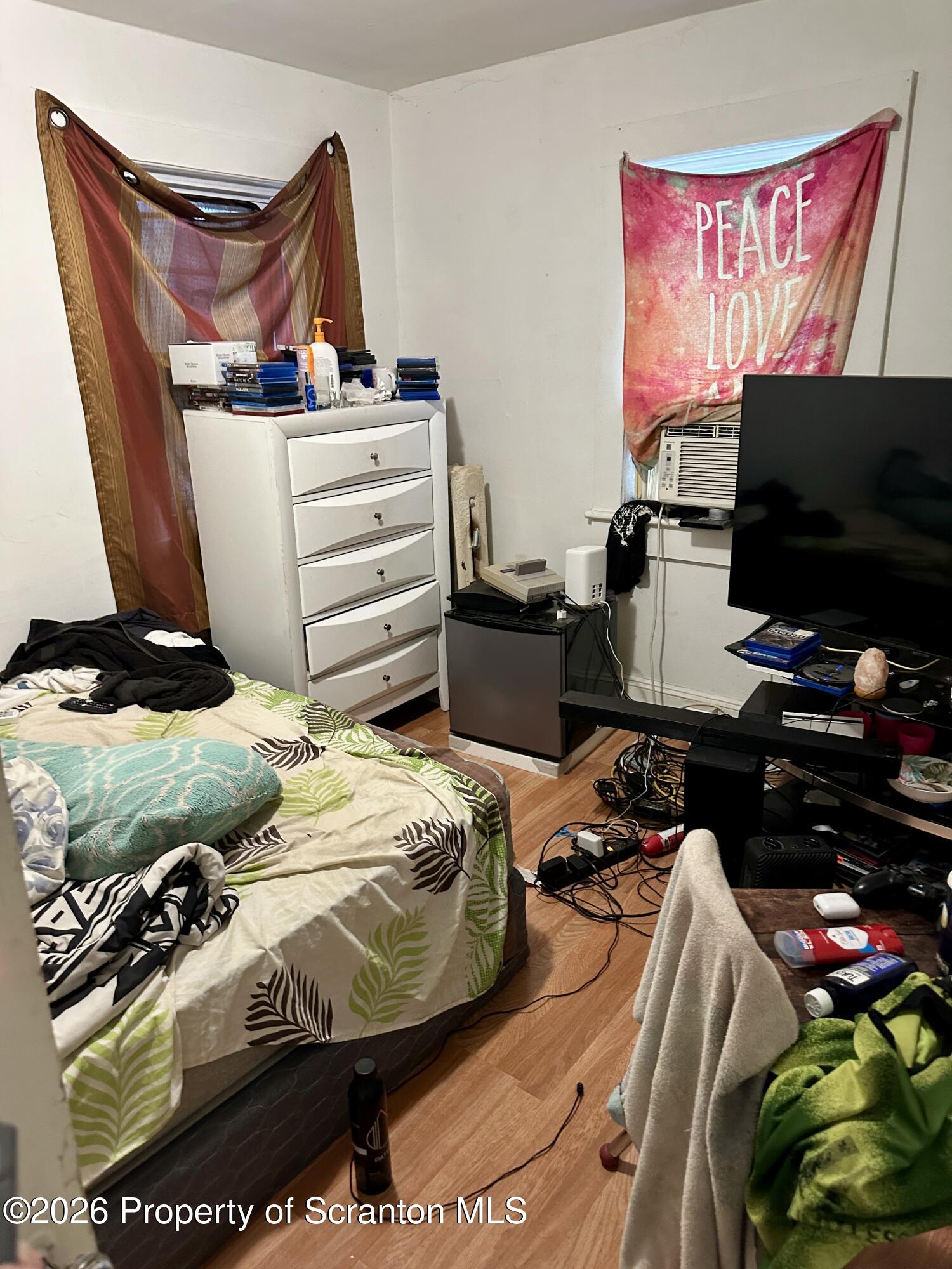 1129-1131 Hampton Street Scranton, PA 18504 - Photo 35 of 45 a bedroom with a bed and a flat screen tv