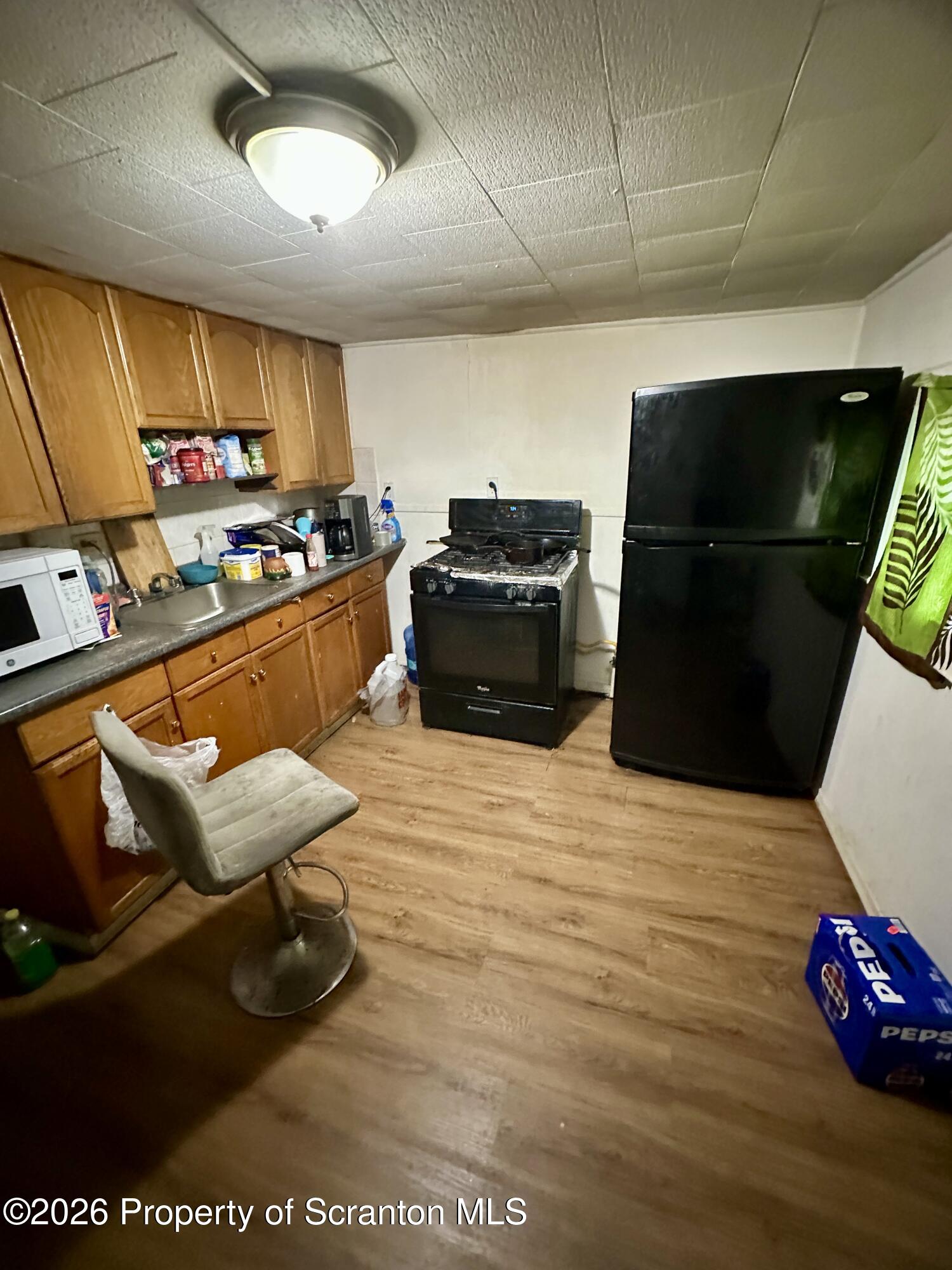 1129-1131 Hampton Street Scranton, PA 18504 - Photo 39 of 45 a kitchen with stainless steel appliances kitchen island granite countertop a refrigerator and a stove