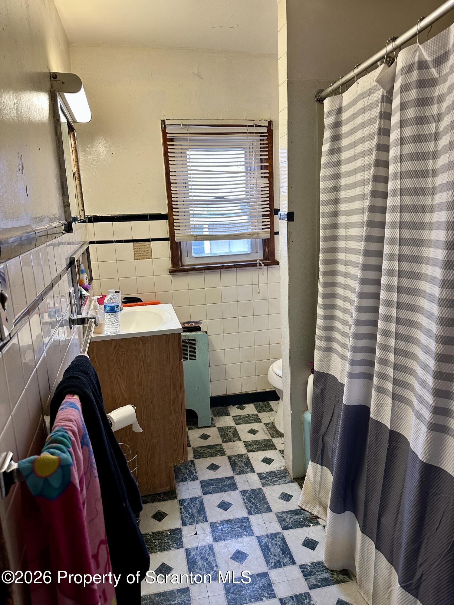 1129-1131 Hampton Street Scranton, PA 18504 - Photo 40 of 45 a living room with a couch and a rug