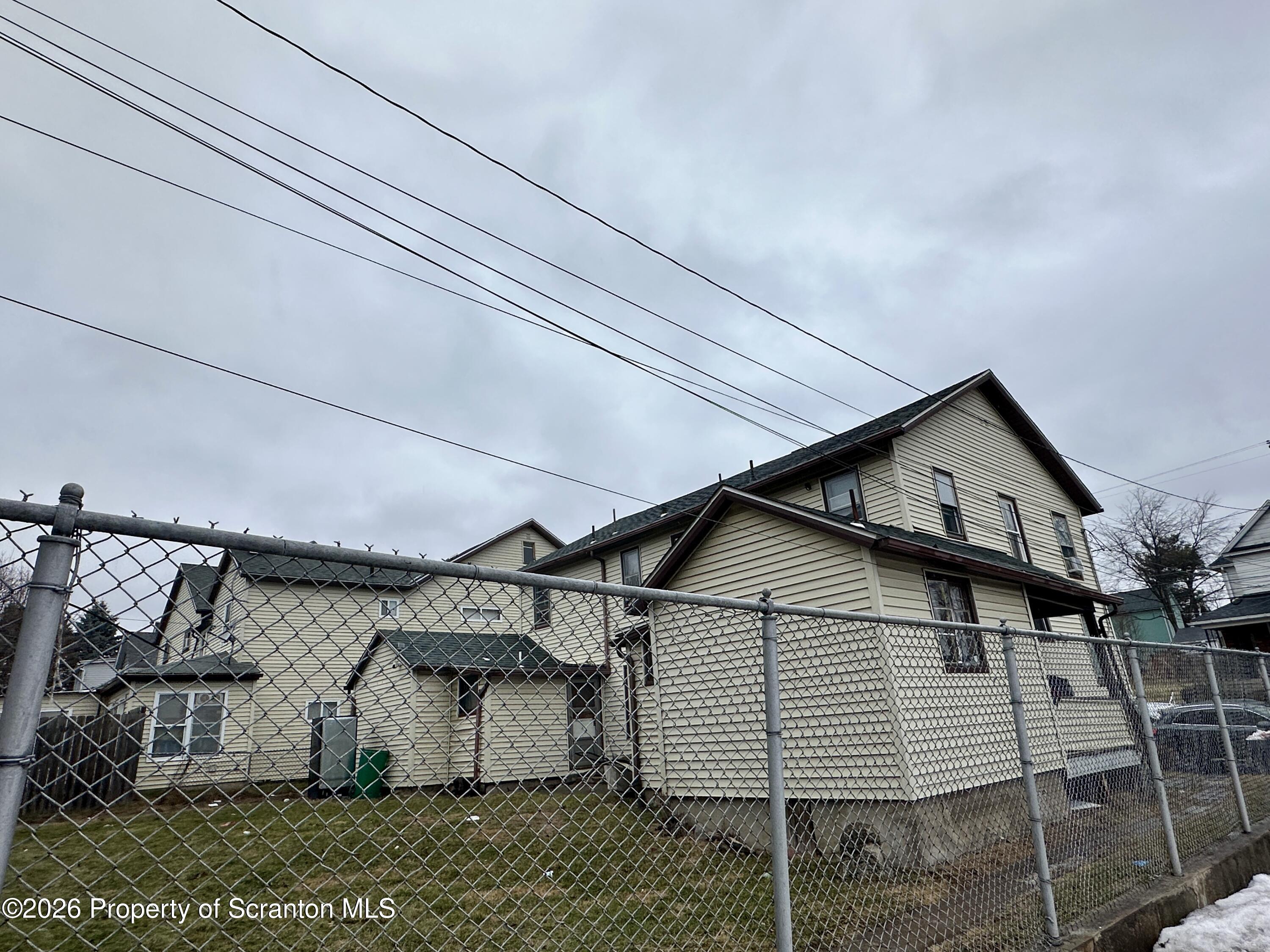 1129-1131 Hampton Street Scranton, PA 18504 - Photo 4 of 45 a view of a white house next to a yard