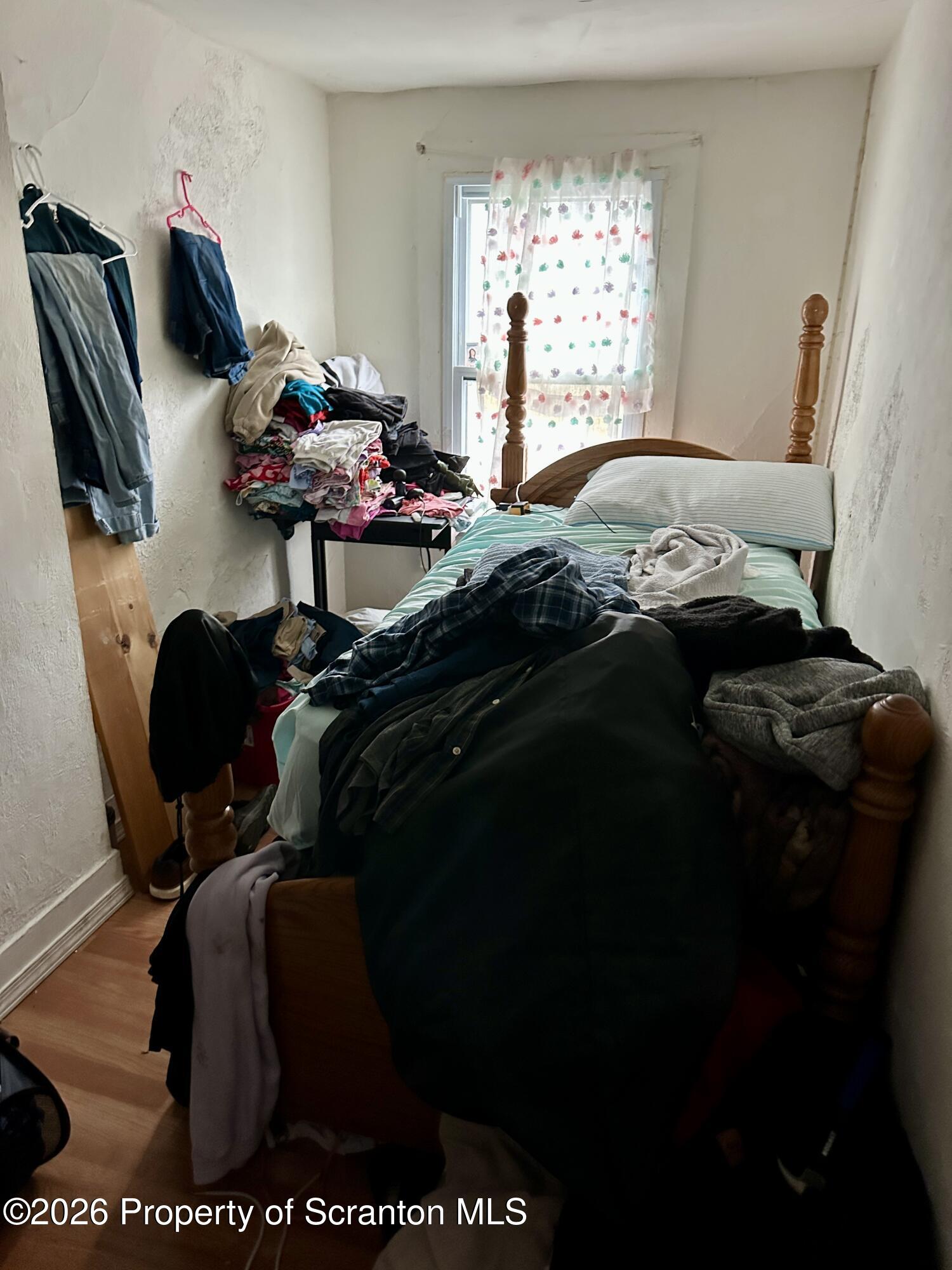 1129-1131 Hampton Street Scranton, PA 18504 - Photo 41 of 45 a bedroom with a bed and window