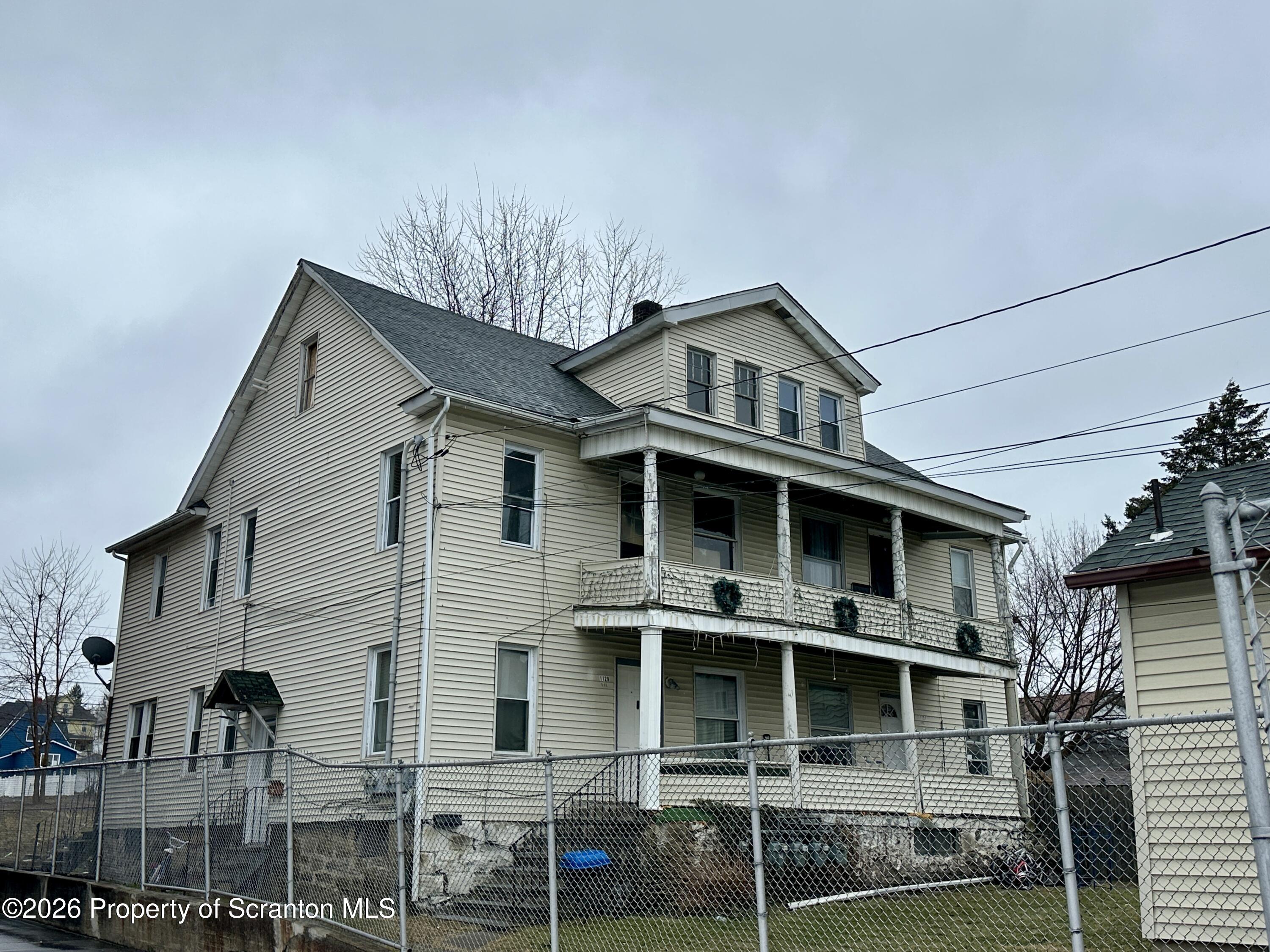 1129-1131 Hampton Street Scranton, PA 18504 - Photo 5 of 45 a front view of a house with windows