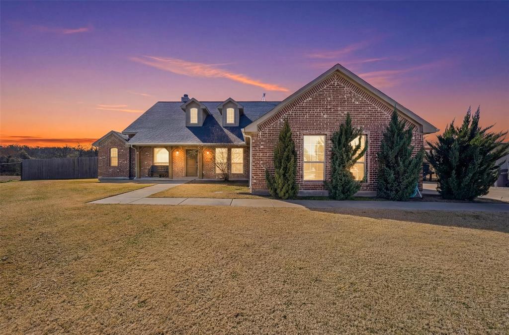 144 Brady Coleman Lane Springtown, TX 76082 - Photo 1 of 37 a front view of a house with a yard