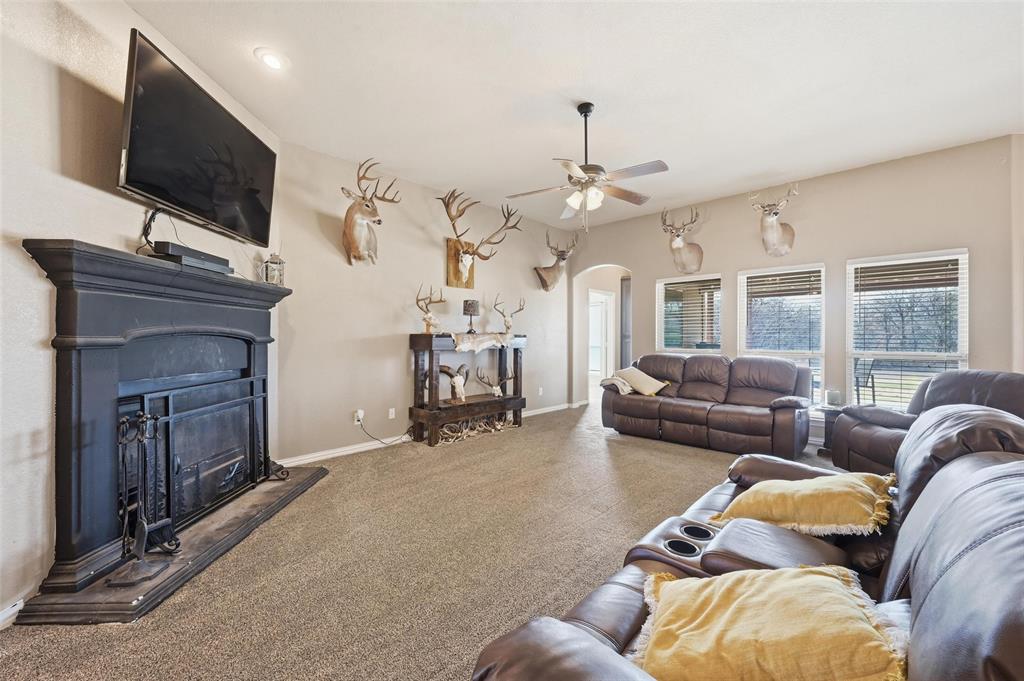 144 Brady Coleman Lane Springtown, TX 76082 - Photo 12 of 37 a living room with furniture and a flat screen tv