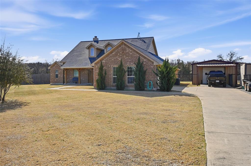 144 Brady Coleman Lane Springtown, TX 76082 - Photo 2 of 37 a view of a house with a yard and potted plants