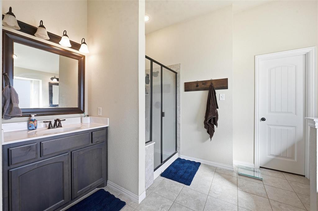 144 Brady Coleman Lane Springtown, TX 76082 - Photo 22 of 37 a bathroom with a double vanity sink mirror and shower