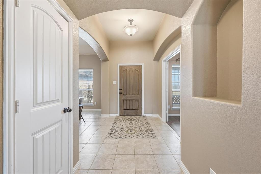 144 Brady Coleman Lane Springtown, TX 76082 - Photo 4 of 37 a view of a hallway with windows and chandelier
