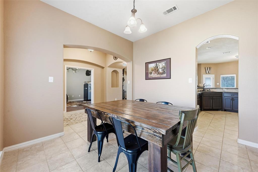 144 Brady Coleman Lane Springtown, TX 76082 - Photo 7 of 37 a view of a dining room with furniture and a chandelier